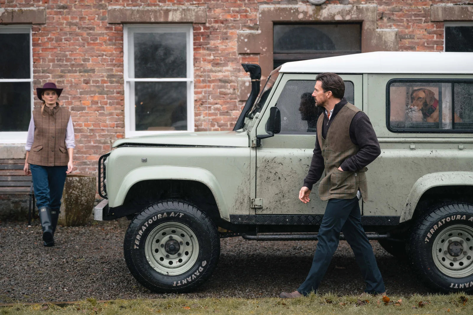 Country clothing and wellington boots beside a Land Rover before a day in the field