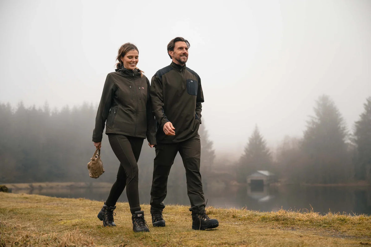 Two walkers in dark outdoor trousers and walking boots on a misty autumn day